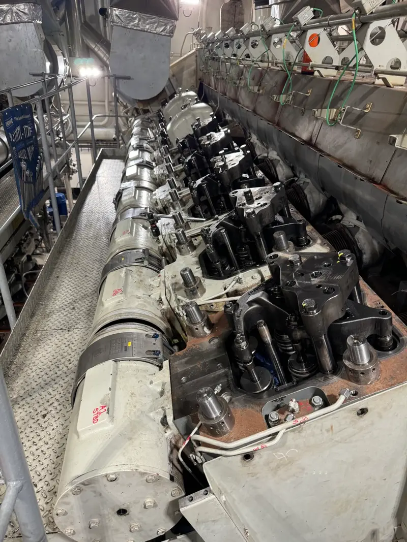 Technician working inside confined engine housing